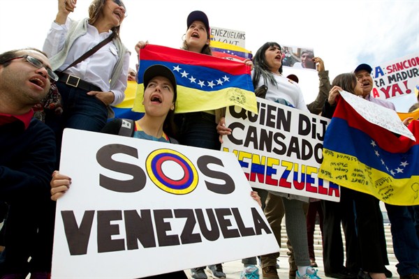 Demonstrators who oppose the Venezuelan government chant outside of the Organization of American States during a meeting on recent events in Venezuela, Washington, April 3, 2017 (AP photo by Jose Luis Magana).