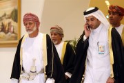 Omani Minister for Foreign Affairs Yousif bin Alawi bin Abdullah, left, arrives at the Gulf Cooperation Council foreign ministers meeting in Doha, Qatar, Dec. 9, 2014 (AP photo by Osama Faisal).