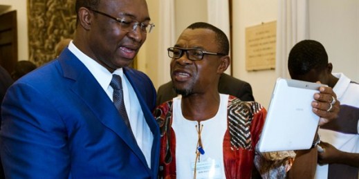 Jean-Rock Sobi, right, representative of the Democratic Front of the Central African People, talks with Anicet Dologuele of the Union for Central African Renewal after signing a peace deal, Rome, June 19, 2017 (AP photo by Domenico Stinellis).