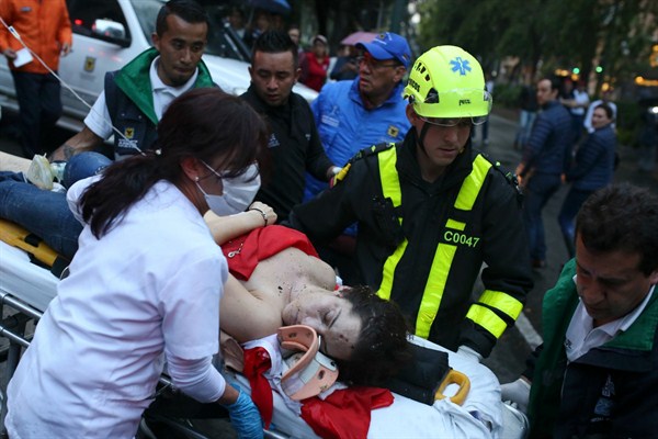 An injured woman is evacuated on a gurney after an explosion at the Centro Andino shopping center in Bogota, Colombia, June 17, 2017 (AP photo by Ricardo Mazalan).