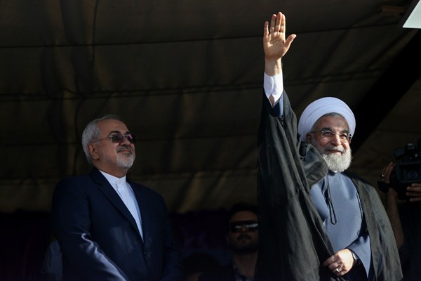 Iranian President Hassan Rouhani, right, accompanied by Foreign Minister Mohammad Javad Zarif, waves to his supporters during a campaign rally, Isfahan, Iran, May 14, 2017 (AP photo by Vahid Salemi).