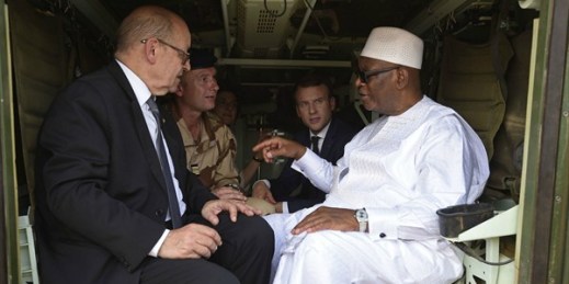 Mali’s president, Ibrahim Boubacar Keita, speaks with French Foreign Minister Jean-Yves Le Drian and French President Emmanuel Macron during their visit with soldiers from Operation Barkhane, Gao, Mali, May 19, 2017 (AP photo by Christophe Petit).