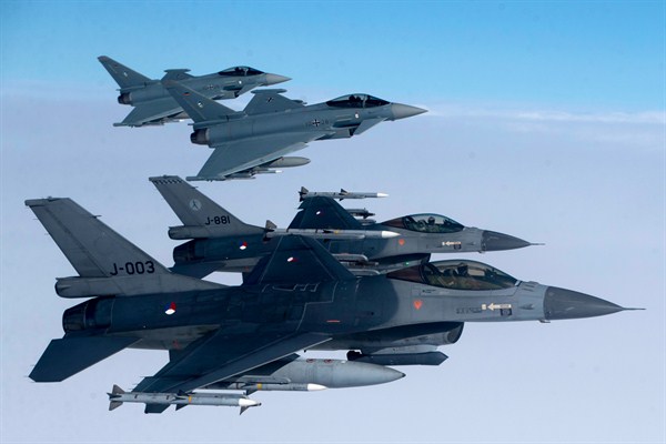 Royal Netherlands Air Force F-16 military fighter jets and German Eurofighter Typhoon fighter jets participate in NATO’s Baltic air policing mission, Lithuania, April 25, 2017 (AP photo by Mindaugas Kulbis).