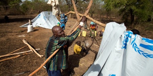 A refugee builds a temporary shelter in the Imvepi camp, Uganda, April 6, 2017 (AP photo by Jerome Delay).