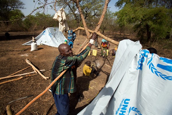 A refugee builds a temporary shelter in the Imvepi camp, Uganda, April 6, 2017 (AP photo by Jerome Delay).