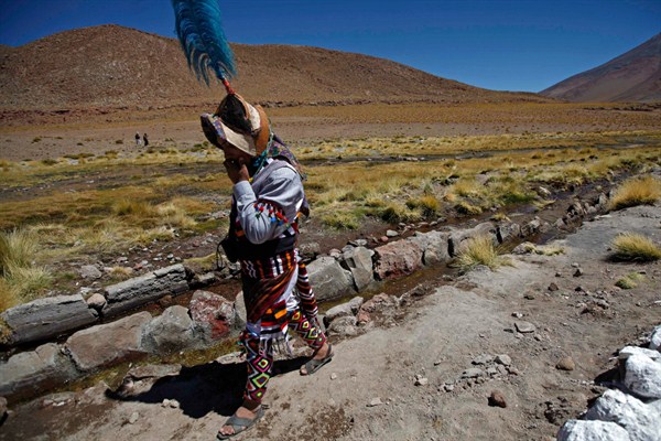 A Quechua indigenous person walks beside the stream of the Silala River, Potosi, Bolivia, March 28, 2013 (AP photo by Juan Karita).
