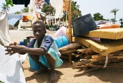 A Senegalese boy from the southern Casamance region waits by his family’s belongings at a camp for those displaced by fighting south of Ziguinchor, Senegal, April 7, 2006 (AP photo by Laurent Emmanuel).