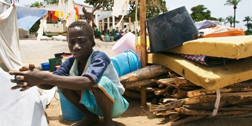 A Senegalese boy from the southern Casamance region waits by his family’s belongings at a camp for those displaced by fighting south of Ziguinchor, Senegal, April 7, 2006 (AP photo by Laurent Emmanuel).