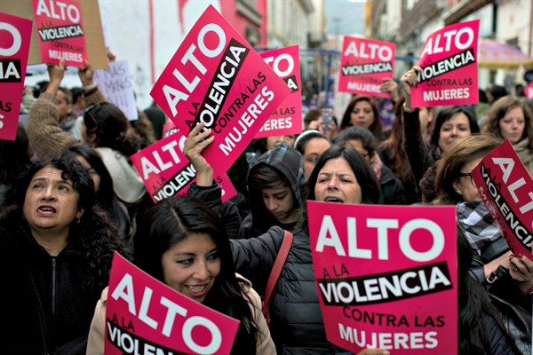 Activists with signs that read in Spanish, “Stop violence against women,” during a march against gender violence, La Paz, Bolivia, Oct. 19, 2016 (AP photo by Juan Karita).