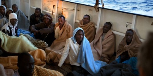 Migrants sit on the deck of a rescue vessel after being rescued on the Mediterranean Sea, 20 miles north of Zuwarah, Libya, June 21, 2017 (AP photo by Emilio Morenatti).
