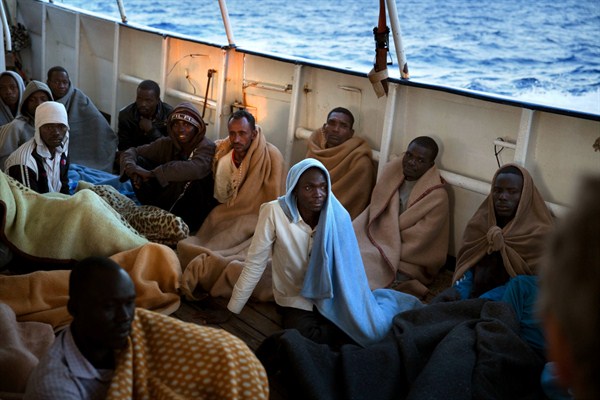 Migrants sit on the deck of a rescue vessel after being rescued on the Mediterranean Sea, 20 miles north of Zuwarah, Libya, June 21, 2017 (AP photo by Emilio Morenatti).