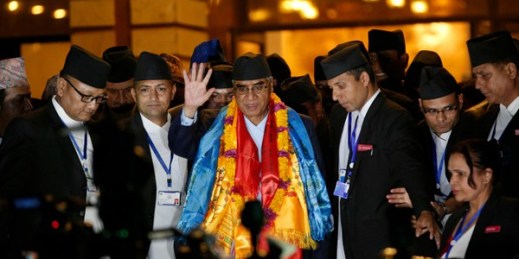 Nepal's new prime minister, Sher Bahadur Deuba, waves to the media at the Parliament House in Kathmandu after his election, June 6, 2017 (AP photo by Niranjan Shrestha).