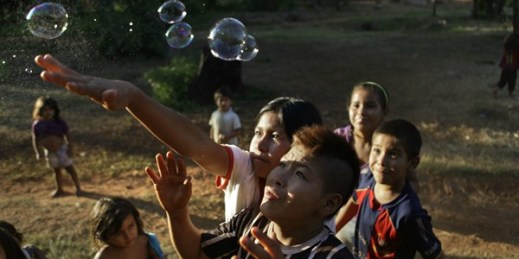 Ache children play with bubbles while celebrating the 12th anniversary of the village of Kuetuvy, Paraguay, Jan. 20, 2013 (AP photo by Jorge Saenz).