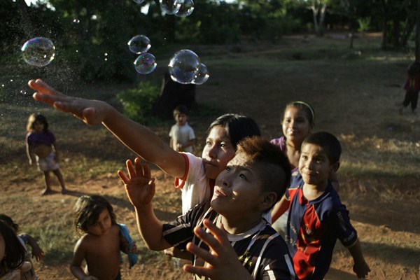 Ache children play with bubbles while celebrating the 12th anniversary of the village of Kuetuvy, Paraguay, Jan. 20, 2013 (AP photo by Jorge Saenz).