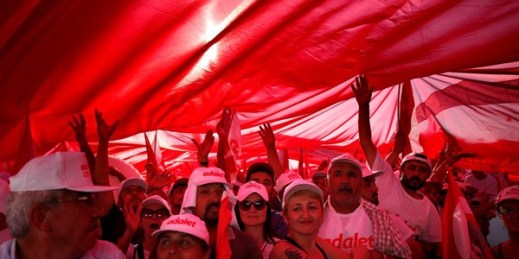 Supporters of Turkish opposition leader Kemal Kilicdaroglu hold a huge Turkish flag as they gather for a rally following the “March for Justice,” Istanbul, July 9, 2017 (AP photo by Lefteris Pitarakis).