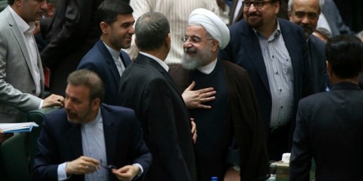 Iranian President Hassan Rouhani leaves parliament after speaking as part of a debate over his proposed Cabinet, Tehran, Aug. 15, 2017 (AP photo by Vahid Salemi).