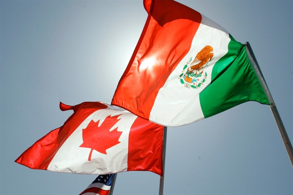 National flags representing Canada, Mexico, and the United States fly outside a meeting between the leaders of the NAFTA countries, New Orleans, April 21, 2008 (AP photo by Judi Bottoni).