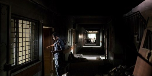 An Iraqi policeman inside Mosul's main hospital complex after it was retaken from Islamic State militants, July 4, 2017 (AP photo by Felipe Dana).
