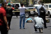 People take photos at the spot where journalist Javier Valdez was killed, Culiacan, Mexico, May 15, 2017 (AP photo by Fernando Brito).