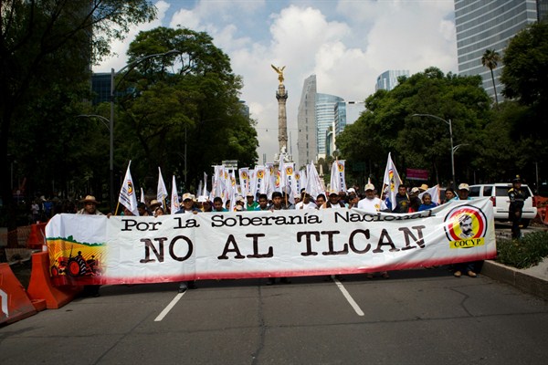 Farmers carry a banner that reads in Spanish "For national sovereignty, no to NAFTA!" during a march protesting the North American Free Trade Agreement, Mexico City, July 26, 2017 (AP photo by Rebecca Blackwell).