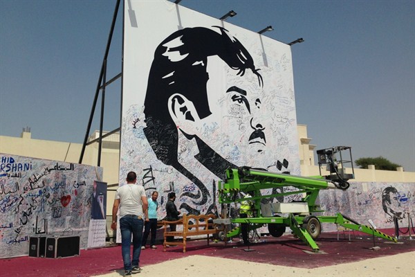 A black-and-white depiction of Qatar’s emir, Sheikh Tamim bin Hamad Al Thani, attracts signatures and comments of support amid a diplomatic crisis between Qatar and neighboring Arab countries, Doha, Qatar, July 3, 2017 (AP photo by Maggie Hyde).