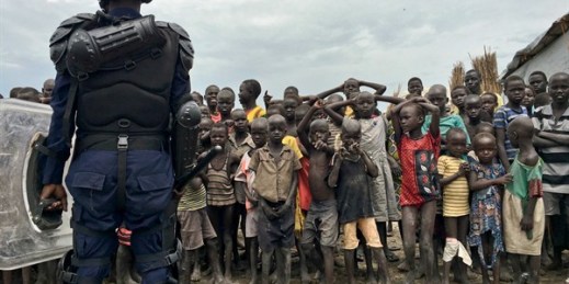 A crowd of displaced people look on as members of the U.N. multinational police contingent provide security during a visit of UNHCR High Commissioner Filippo Grandi, Bentiu, South Sudan, June 18, 2017 (AP photo by Sam Mednick).