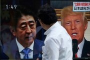 A man walks past a TV news screen showing Japanese Prime Minister Shinzo Abe and U.S. President Donald Trump, while reporting North Korea's a possible nuclear test, Tokyo, Sept. 3, 2017 (AP photo by Eugene Hoshiko).