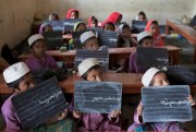 Bangladeshi students display their handwriting on their blackboards at an Islamic education school, Dhaka, Bangladesh, Sept. 9, 2014 (AP photo by A.M. Ahad).