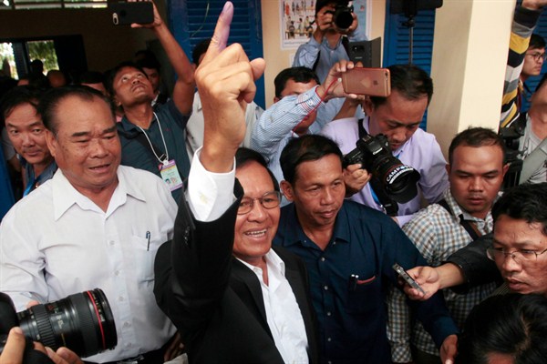 Kem Sokha, a Cambodian opposition leader who was arrested earlier this month, shows his inked finger after voting in local elections on the outskirts of Phnom Penh, Cambodia, June 4, 2017 (AP photo by Heng Sinith).