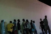 Security forces line up Sudanese migrants detained at a police station after they were rescued from a boat that capsized in the Mediterranean Sea, Rosetta, Egypt, Sept. 21, 2016 (AP photo by Eman Helal).