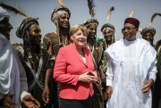 German Chancellor Angela Merkel is greeted by Niger’s president, Mahamadou Issoufou, and members of the Wodaabe ethnic group, Niamey, Niger, Oct. 10, 2016 (Dpa photo by Michael Kappeler via AP)