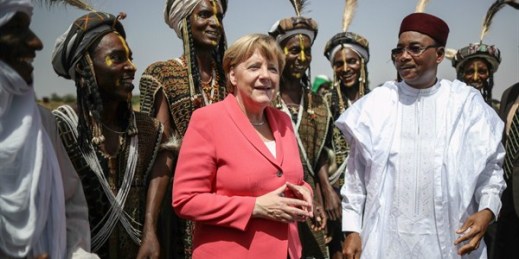 German Chancellor Angela Merkel is greeted by Niger’s president, Mahamadou Issoufou, and members of the Wodaabe ethnic group, Niamey, Niger, Oct. 10, 2016 (Dpa photo by Michael Kappeler via AP)