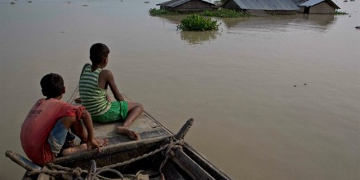 Villagers travel by boat in floodwaters in Assam state, northeast India, Aug. 15, 2017 (AP photo by Anupam Nath).