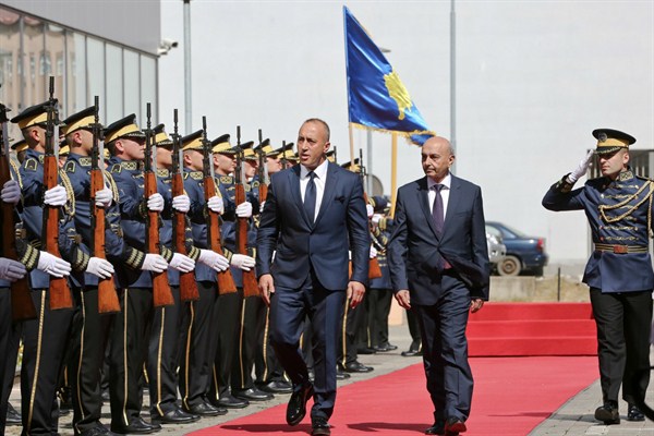 Kosovo’s newly elected prime minister, Ramush Haradinaj, left, and outgoing prime minister, Isa Mustafa, during a handover ceremony, Pristina, Kosovo, Sept. 11, 2017 (AP photo by Visar Kryeziu).