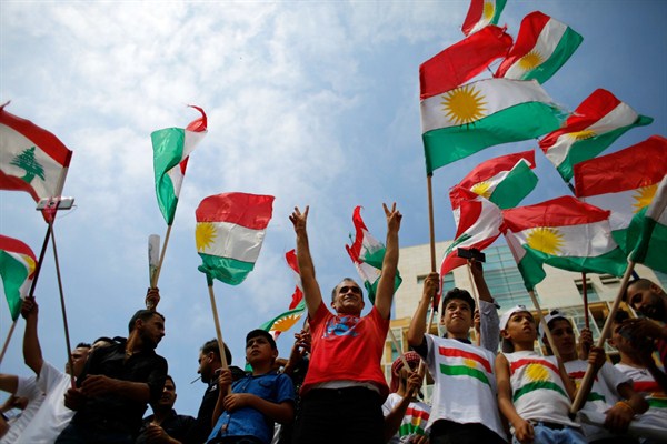 Kurds wave Kurdish flags and flash the victory sign as they gather to support the referendum in Iraq, Beirut, Lebanon, Sept. 17, 2017 (AP photo by Hassan Ammar).