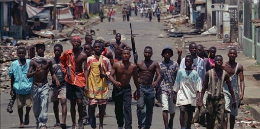 Rebel fighters move through the deserted streets of downtown Monrovia, Liberia, May 18, 1996 (AP photo by David Guttenfelder).