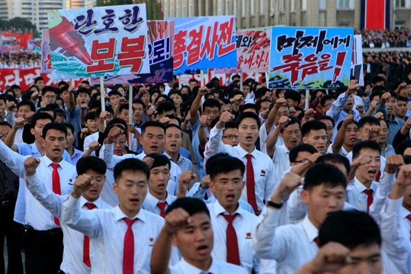 North Koreans attend a mass rally against the U.S., bearing signs that read "decisive revenge" and "death to the American imperialists," Pyongyang, North Korea, Sept. 23, 2017 (AP photo by Jon Chol Jin).