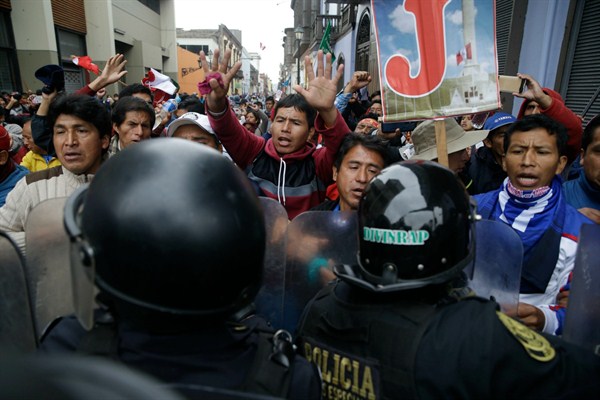 Striking school teachers shout at police blocking them from reaching Congress, Lima, Peru, Aug. 24, 2017 (AP photo by Martin Mejia).