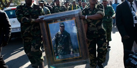 Members of Umkhonto we Sizwe, the armed wing of the African National Congress in South Africa, hold a frame photograph of former South African President Nelson Mandela, Pretoria, South Africa, June 20, 2013 (AP photo by Markus Schreiber).