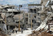 Residents walk through the rubble of the resort town of Zabadani in the Damascus countryside, Syria, May 18, 2017 (AP photo by Hassan Ammar).