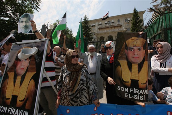 Turkish supporters of former Egyptian President Mohammed Morsi protest with a portrait of current Egyptian President Abdel Fattah el-Sissi, depicted as the "last pharaoh," Ankara, Turkey, July 13, 2013 (AP photo by Burhan Ozbilici).