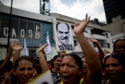 Supporters of Venezuela’s government march with pictures of opposition leaders blaming them for U.S. sanctions, Caracas, Venezuela, Sept. 11, 2017 (AP photo by Ariana Cubillos).