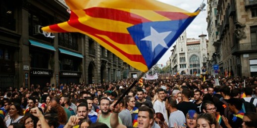 Pro-independence demonstrators wave an “estelada,” or Catalonian independence flag, in front of a Spanish police station, Barcelona, Spain, Oct. 3, 2017 (AP photo by Francisco Seco).