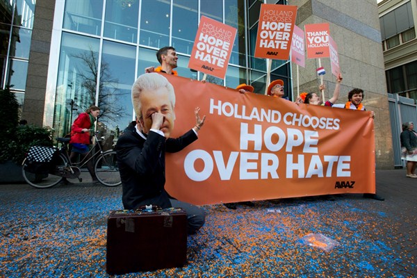 A man poses as a crying Geert Wilders, the firebrand anti-Islam lawmaker, during a small demonstration outside parliament in The Hague, Netherlands, March 16, 2017 (AP photo by Peter Dejong).
