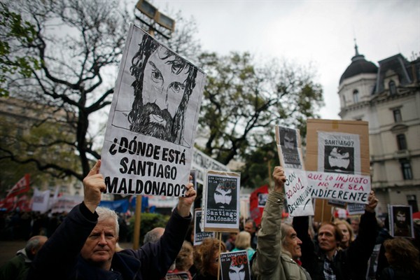 People hold drawings and photos of Santiago Maldonado during a demonstration at Plaza de Mayo, Buenos Aires, Argentina, Oct. 1, 2017 (AP photo by Victor R. Caivano).