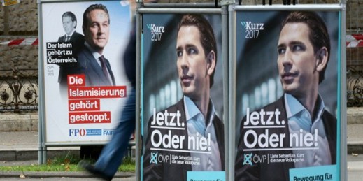 A person passes posters of the right-wing Freedom party, FPOE, and the conservative Austrian People's Party, OEVP, Vienna, Austria, Oct.11, 2017 (AP photo by Ronald Zak).