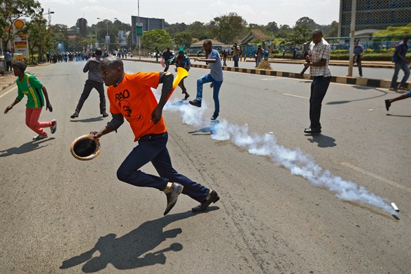 Opposition protesters scatter as police fire tear gas at them during a demonstration in downtown Nairobi, Kenya, Sept. 26, 2017 (AP photo by Ben Curtis).