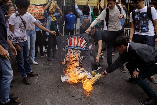 Filipino students burn a caricature depicting President Rodrigo Duterte during a protest in front of the gates of the Malacanang presidential compound, Manila, Philippines, Oct. 19, 2017 (AP photo by Aaron Favila).