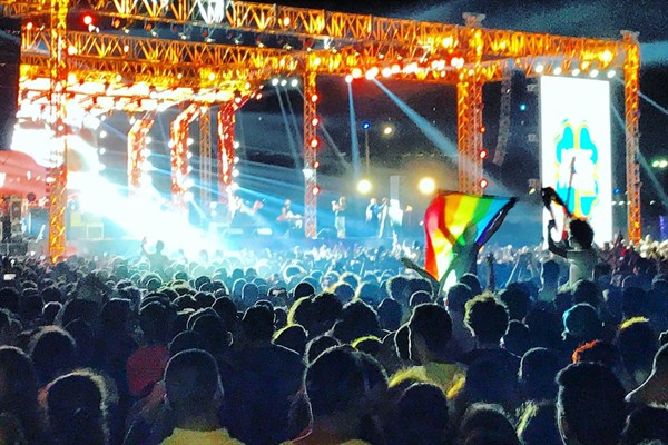Fans of the Lebanese rock group Mashrou' Leila wave a rainbow flag at a concert in Cairo, Egypt, Sept. 22 2017 (DPA photo by Benno Schwinghammer).