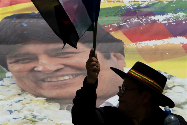 A supporter of Bolivian President Evo Morales waves a party flag during a march supporting his re-election, La Paz, Bolivia, Nov. 7, 2017 (AP photo by Juan Karita).